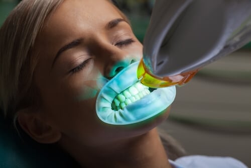 Woman getting teeth whitened