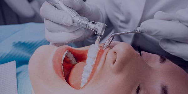 A woman having her teeth cleaned in a dental office